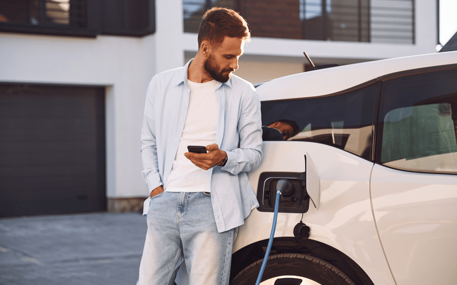 man standing up against EV charging